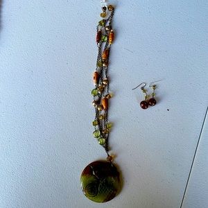 Carved stone pendant with earrings